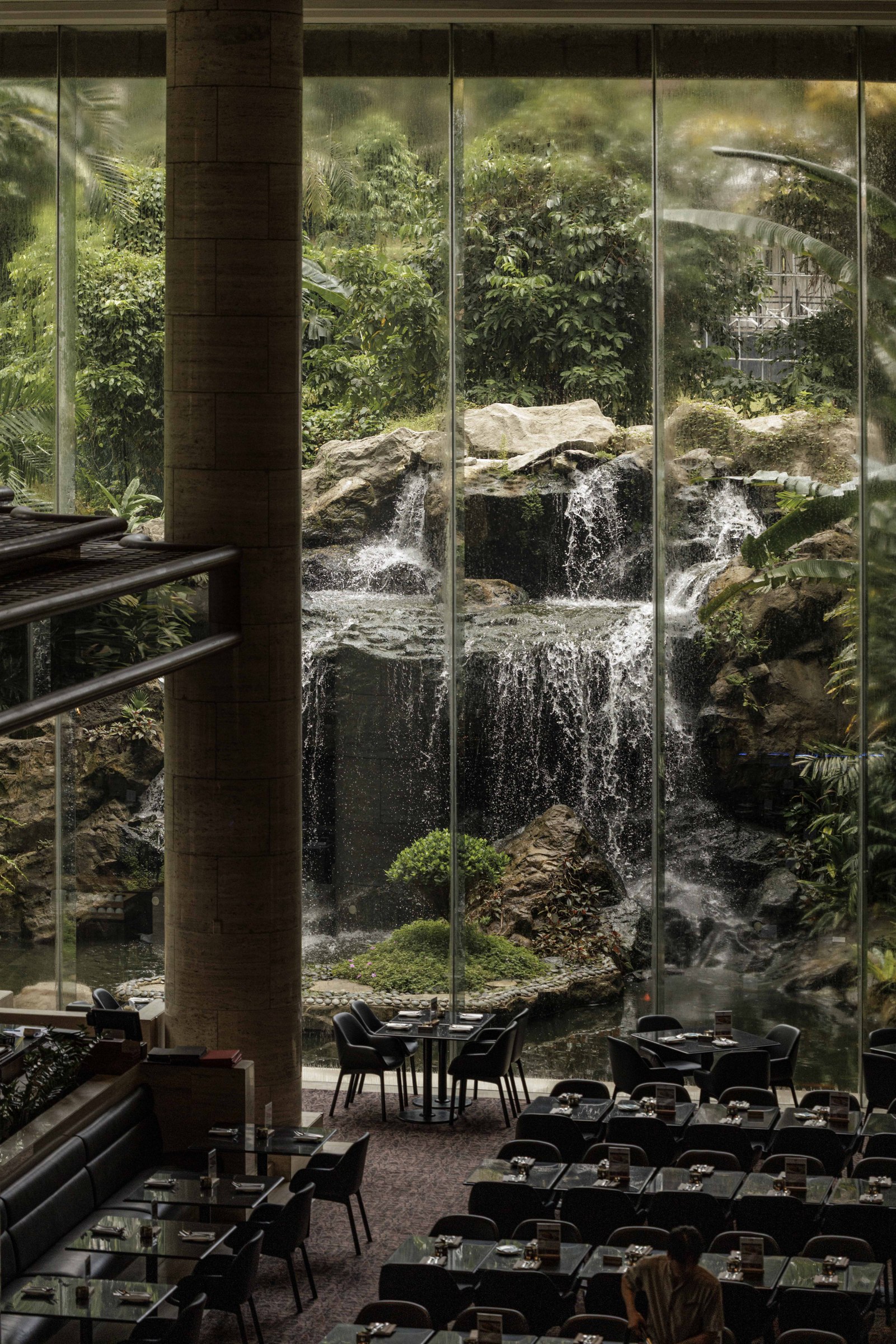 Waterfall and greenery within an interior courtyard
